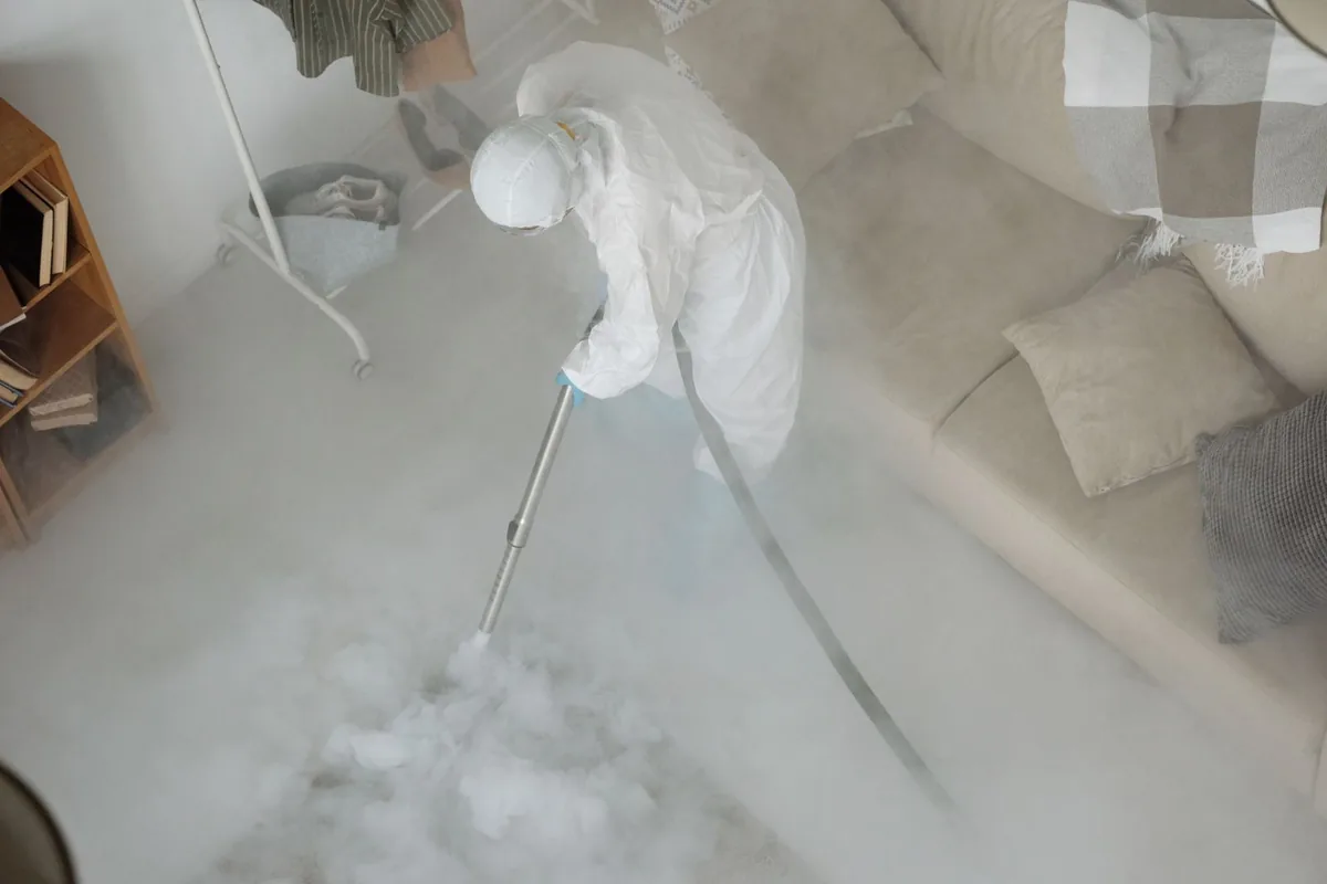 Biohazard cleanup technician in protective equipment, Water Valley, MS
